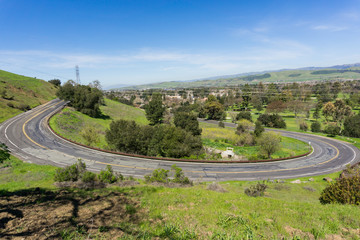 Fototapeta na wymiar Winding paved road in Santa Teresa park, San Jose, Santa Clara county, California