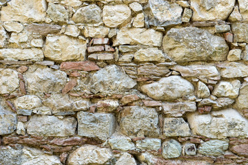 Wall with big and small, bright natural stones