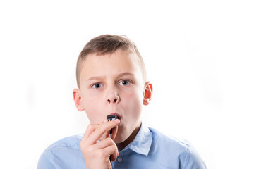 Boy with whistle on white background