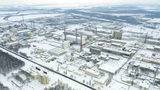Aerial orbit view of chemical industry plant in winter. Air pollution industry. Carcinogenic harm concept