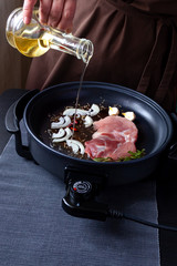 electric pan meat skillet pot connector plug food fry electrical adjustable onion black brown background table