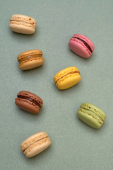 Above view of colorful macaroons on a marble background