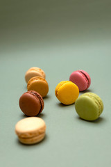 Above view of colorful macaroons on a marble background