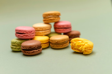 Obraz na płótnie Canvas Front view of colorful macaroons on a marble background