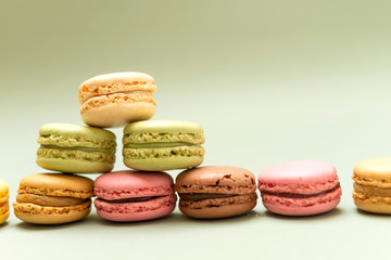 Obraz na płótnie Canvas Front view of colorful macaroons on a marble background
