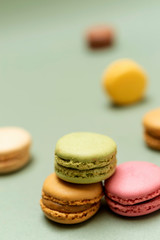Front view of colorful macaroons on a marble background