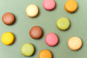Above view of colorful macaroons on a marble background