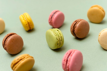 Above view of colorful macaroons on a marble background