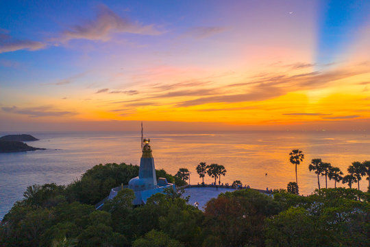 sunset above the great lighthouse at Promthep cape Phuket Thailand