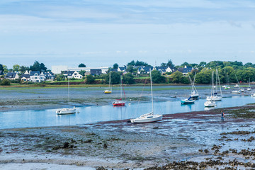 Boats and sailing ships at low tide in the harbour of Larmor-Plage, Lorient, France