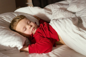 infant baby boy sleeping in bed at night