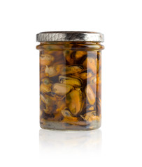 Marinated mussels in a glass jar. Mussels without leaf marinated in a jar on a white background.
