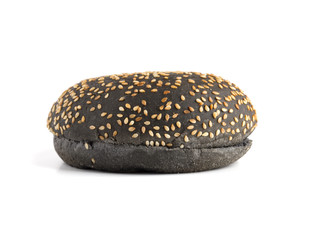 Black burger bun on a white background. Bun cut in half close up on a white background.