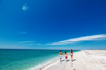 Teenage friends playing on the beach