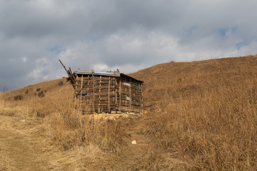 A rural landscape of a farmland and human settlements or huts