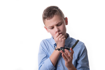 Boy brooding over his future sitting with a compass in his hand and isolated with white background