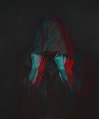 Anaglyph effect of human in black coat with a hood.