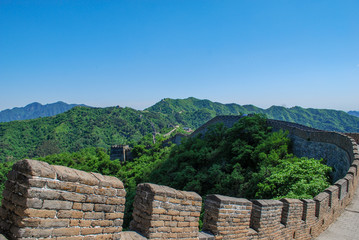 Curved line of the Great Wall of China stretching out along the mountains