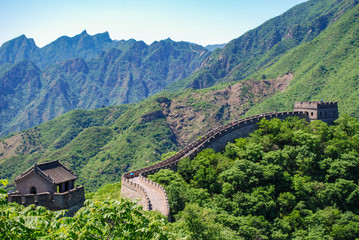 Fototapeta na wymiar Ornate roof on top of the Great Wall of China outpost with the mountains in the background
