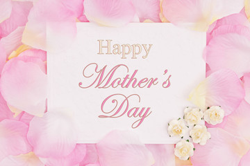 Happy Mother's Day greeting card on pink rose flower petals