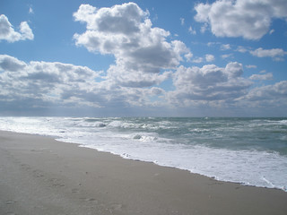 curly white clouds above the sea disturbing