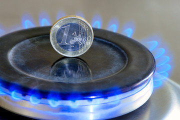 Burning natural gas and one euro coin on gas hob