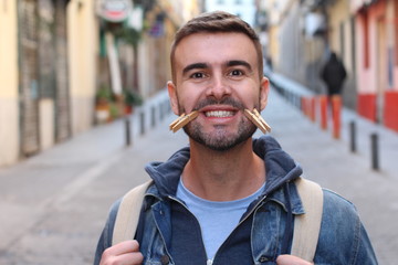 Young male faking smile with clothespins 