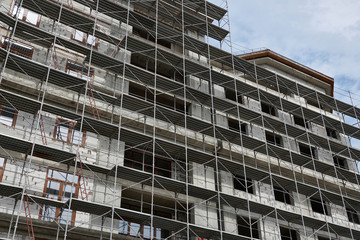 new building under construction, scaffolding and concrete