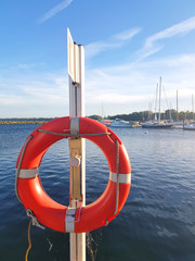 Lifebuoy in red and white color on a wood joist for use in case of emergency