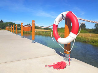 Lifebuoy in red and white color on a wood joist for use in case of emergency