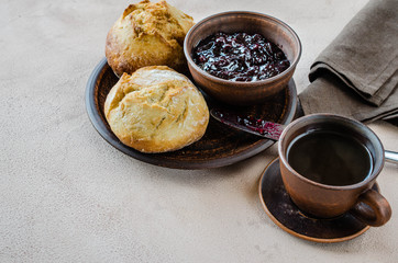 Simple breakfast: coffee americano, fresh buns and jam.