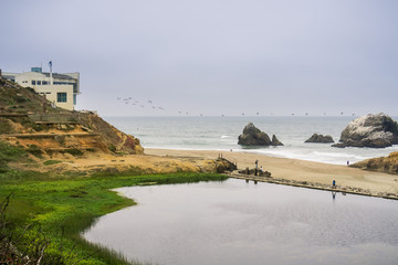 Ruins of the Sutro baths on a cloudy day; the Cliff house in the background, Lands End, San Francisco, California