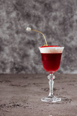 Red cocktail isolated on a black background.
