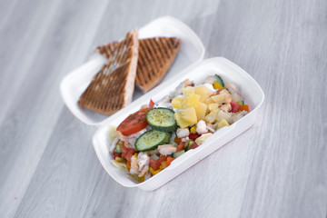 fast food vegetable salad with pineapple and cucumber in box