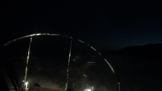 View from of moving airboat air glider on ice at night on background of winter landscape of Lake Baikal in Siberia.