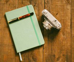 Diary with pen and old camera