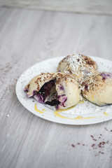 Czech or European typical meal, sweet stuffed dumplings, often with plum, strawberry or another fruit, served with chocolate, cocoa, butter and curd, eaten as a dessert after dish, liked by children