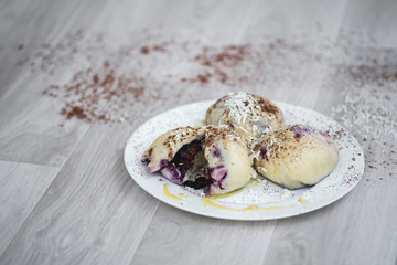 Czech or European typical meal, sweet stuffed dumplings, often with plum, strawberry or another fruit, served with chocolate, cocoa, butter and curd, eaten as a dessert after dish, liked by children