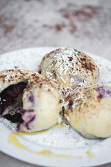 Czech or European typical meal, sweet stuffed dumplings, often with plum, strawberry or another fruit, served with chocolate, cocoa, butter and curd, eaten as a dessert after dish, liked by children