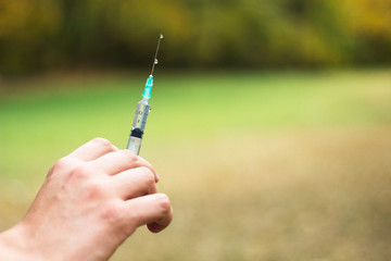 Man hand holding medical syringe