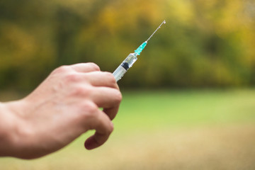 Man hand holding medical syringe