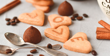 romantic Breakfast: two cups of coffee and cookies in the shape of hearts, on the cookie letters LOVE. the concept of a gift for Valentine's day on February 14. selective focus