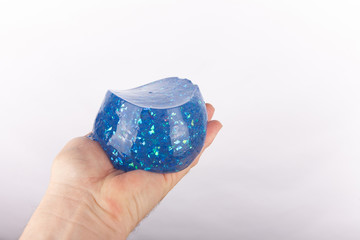 Hand holding a formed blue glitter slime