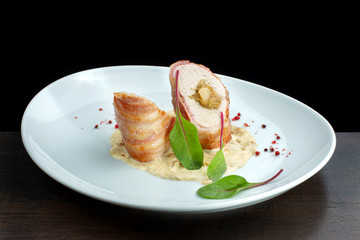 Chicken breast roll with filling. Decorated with herbs.