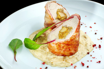 Chicken breast roll with filling. Decorated with herbs.
