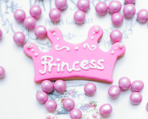 pink color crown shaped Cookie with princess written on it with white fondant  