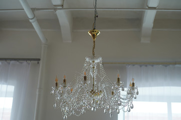 Several crystal chandeliers under the ceiling.Luxury and brilliance
