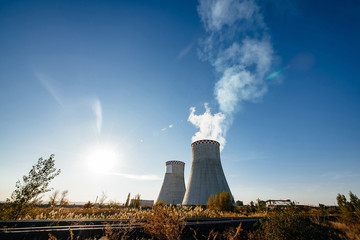 Smoking pipes of thermal power plant against blue sky