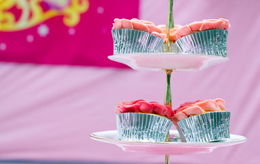 bunch of pink fondant cupcake in ceramic plate 