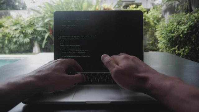 first-person portrait programmer developer programmer freelancer writes code at a laptop outside the office